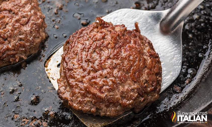 cooked stovetop burger in a cast iron skillet
