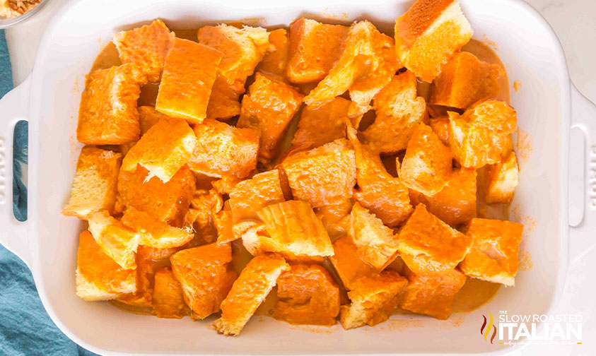 pumpkin custard poured over cubed bread