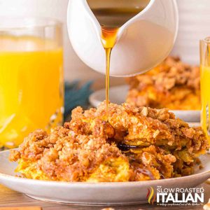 drizziing syrup on pumpkin pie french toast casserole