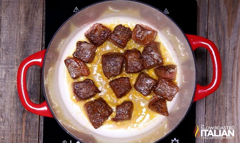 searing pieces of beef in pot for soup