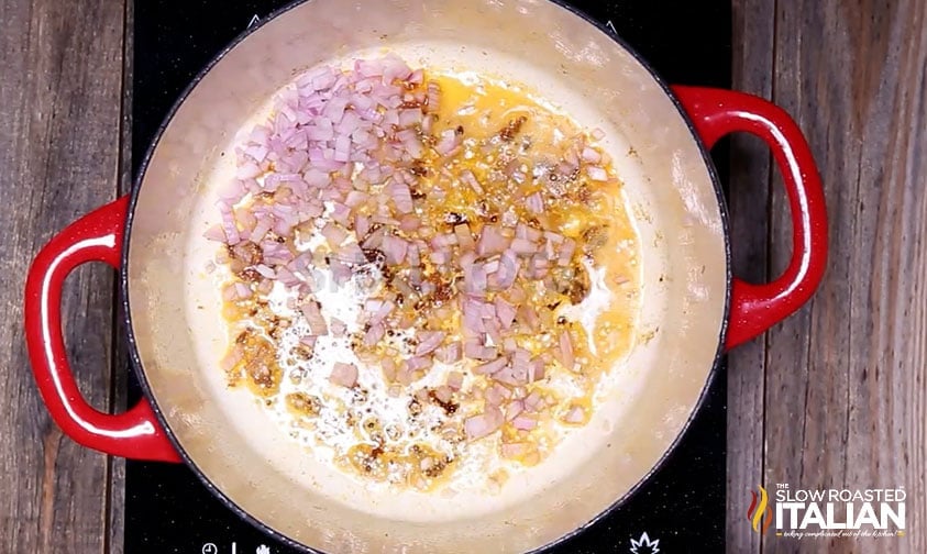 sautรฉing shallots and garlic in pot for hearty beef soup