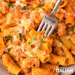closeup of cheesy chicken pasta bake with a fork