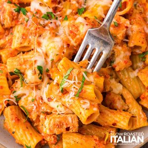 closeup of cheesy chicken pasta bake with a fork