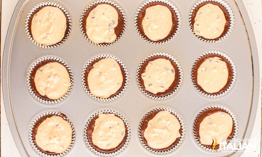 black bottom cupcake batter in lined muffin tin with cream cheese mixture add to top