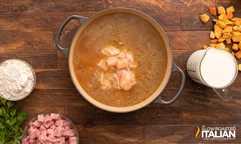 adding bite sized pieces of chicken to cordon bleu soup