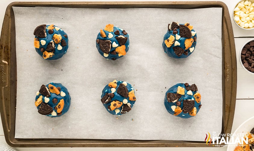 monster cookies dough balls on a baking sheet