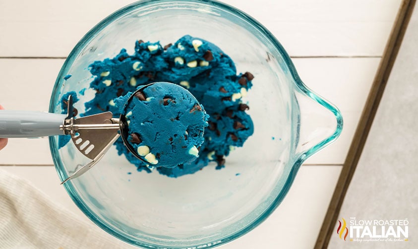 scooping out monster cookie dough with a cookie scoop