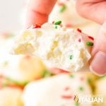 closeup of a hand holding cool whip candy