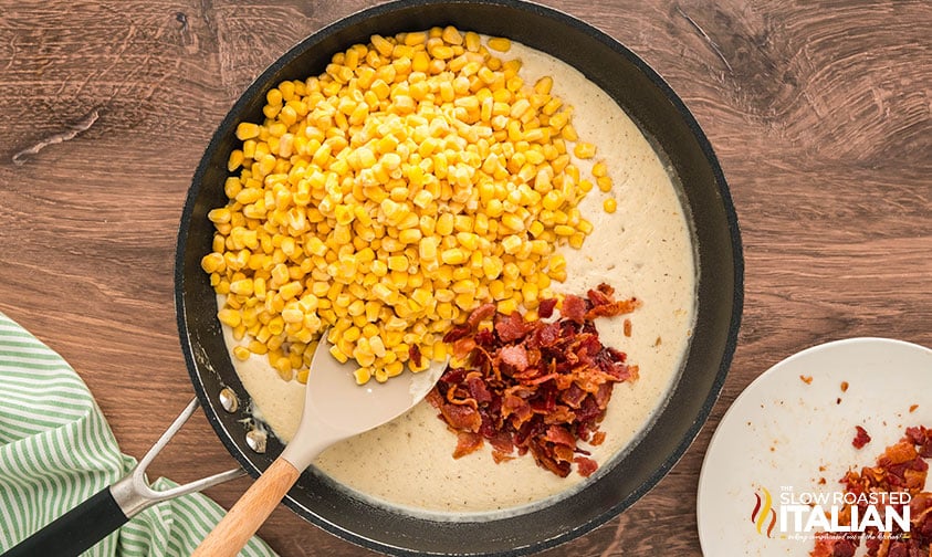 adding corn and bacon to sauce in a large skillet