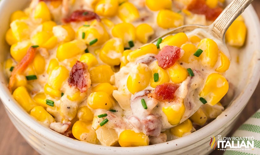 closeup of a bowl of corn and bacon casserole