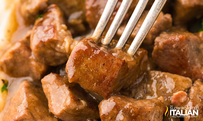 closeup of crockpot steak bites on a fork
