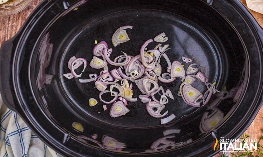 sliced shallots in a crockpot