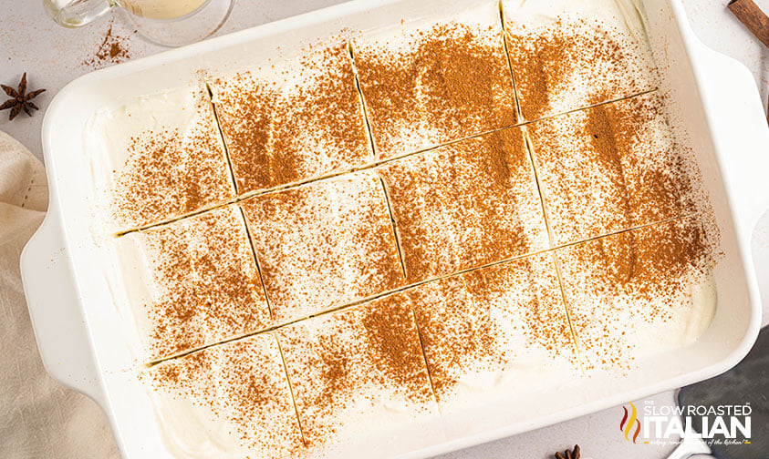 sliced eggnog tres leches cake dusted with cinnamon