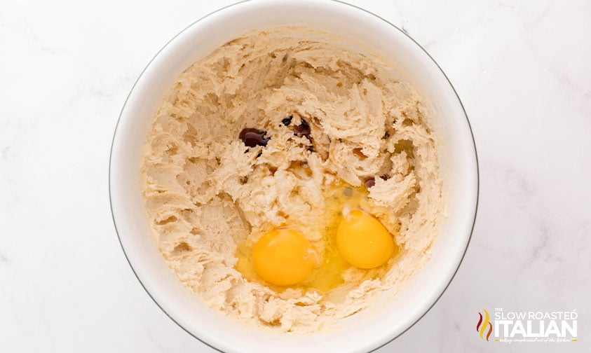 adding eggs and vanilla to christmas cookie dough