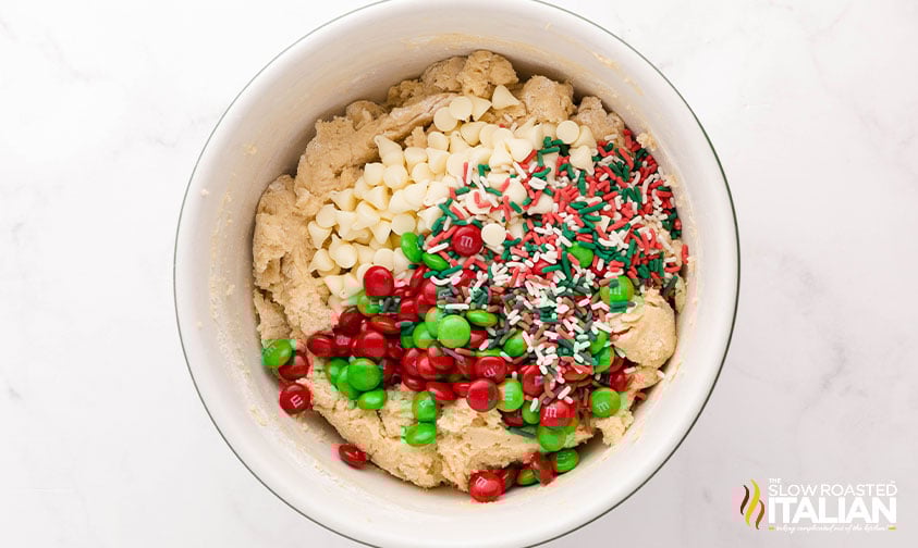 adding m&m's and sprinkles to christmas cookie dough