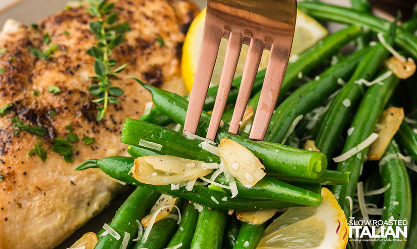 closeup of garlic green beans on a fork