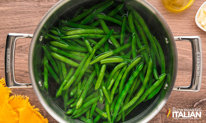 blanched green beans in a pot of water