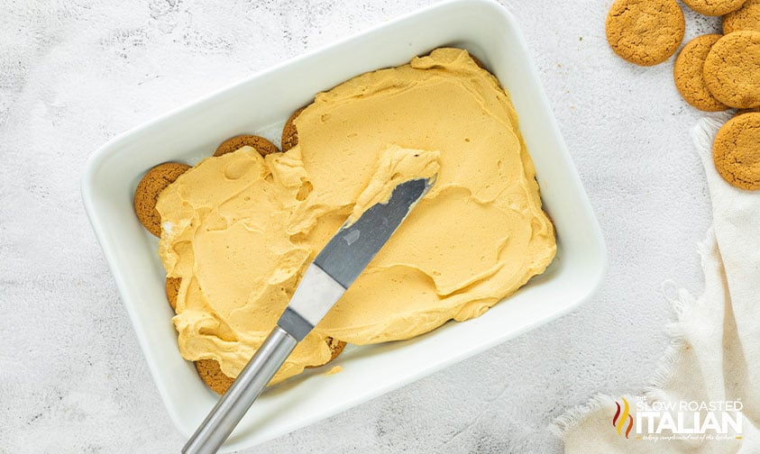 spreading molasses mousse over gingersnap cookies