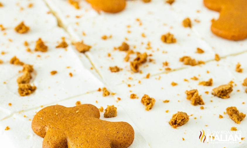 gingerbread men cookies adding to the top of gingerbread layer cake