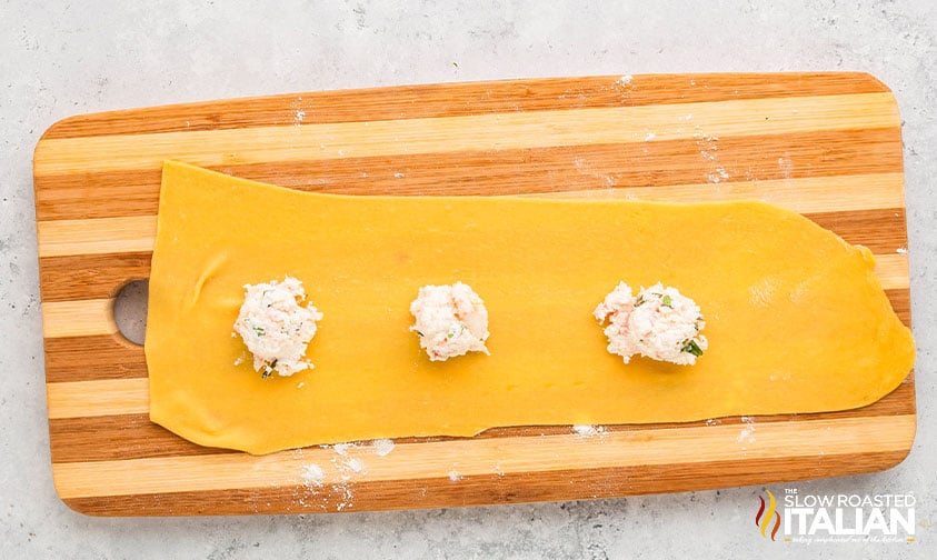 adding lobster ravioli filling to dough