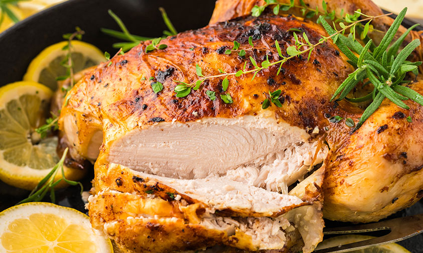 closeup of sliced lemon roasted chicken