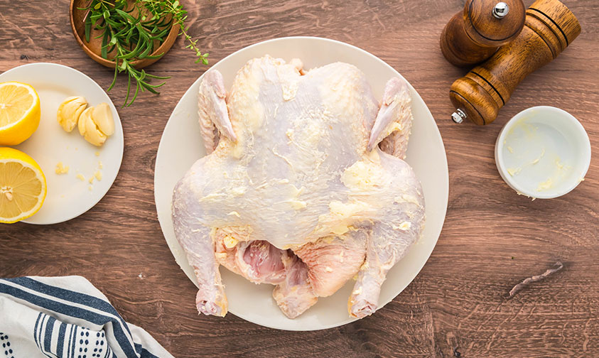 placing seasoning under the chicken skin