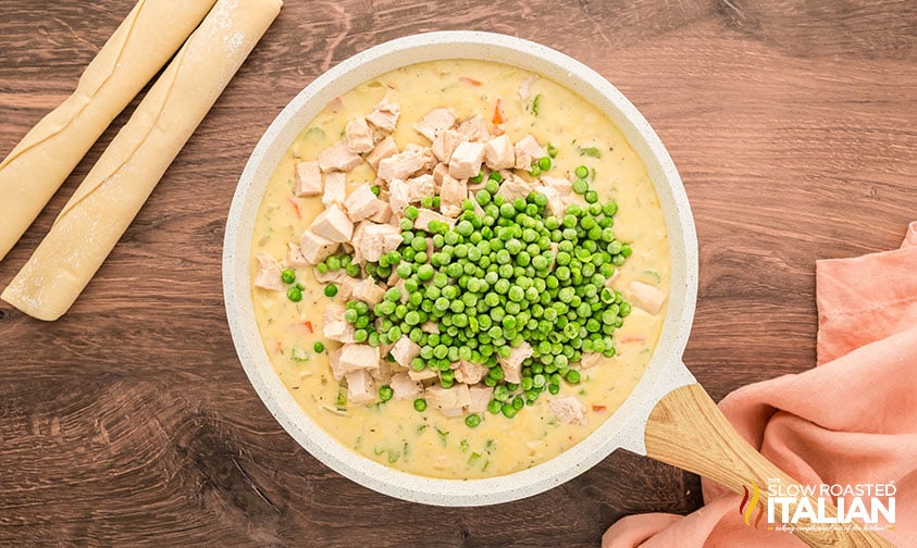adding chicken and peas to chicken pot pie mixture