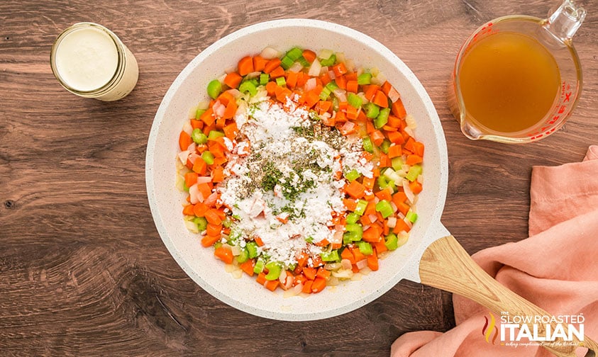 sprinkled flour and seasonings over cooked vegetables and adding chicken stock and heavy cream
