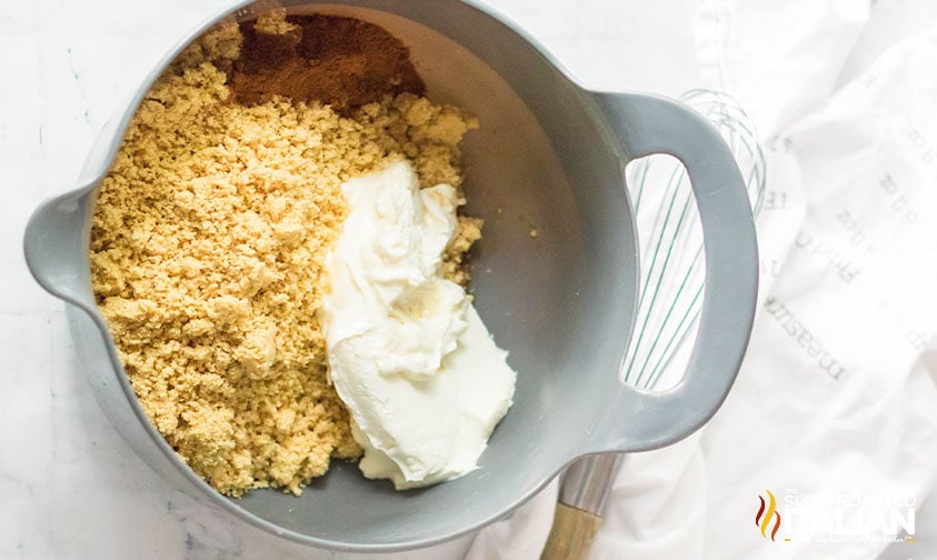 crushed golden oreos and cream cheese in a large mixing bowl