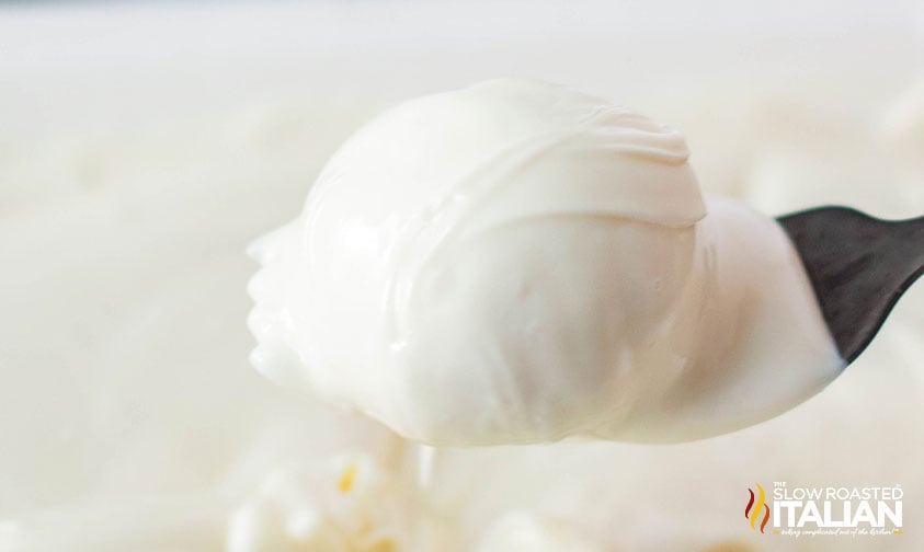 dipping snickerdoodle truffles in melted white chocolate