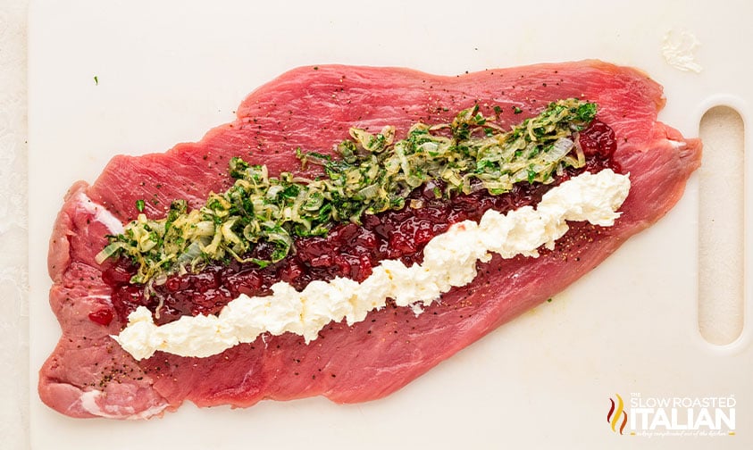 stuffing pork tenderloin with cheese mixture, cranberry sauce, and onions.