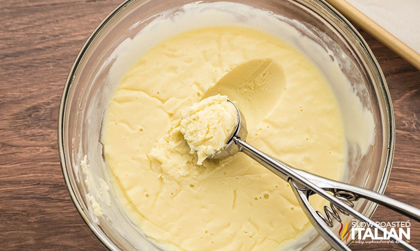 scooping out chocolate ganache for white chocolate truffles