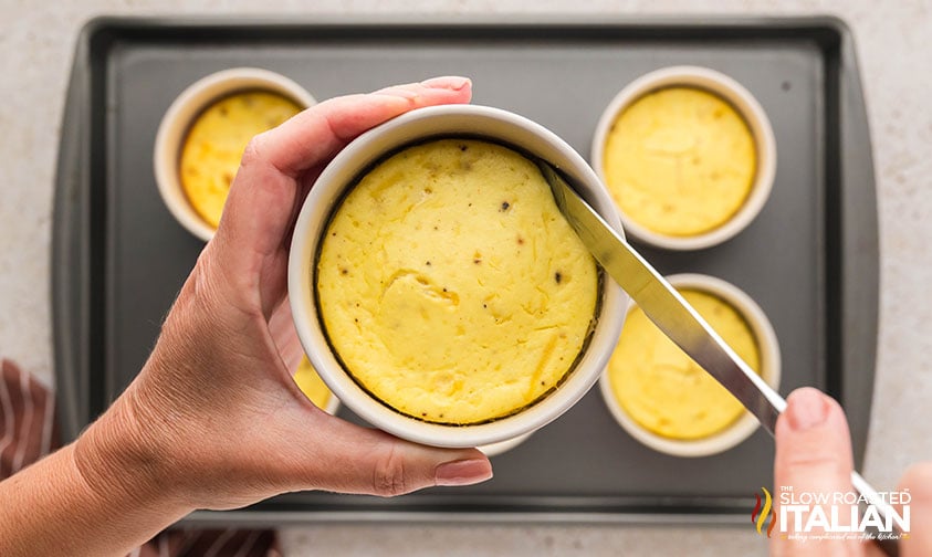 closeup of removing baked ricotta from a ramekin