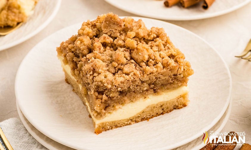 slice of cream cheese coffee cake on a white plate