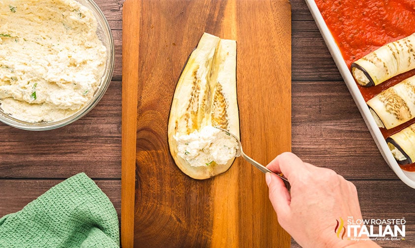 adding filling to sliced eggplant for rallatini