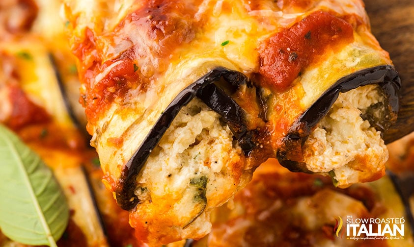 closeup of eggplant rollatini on a wooden serving spoon