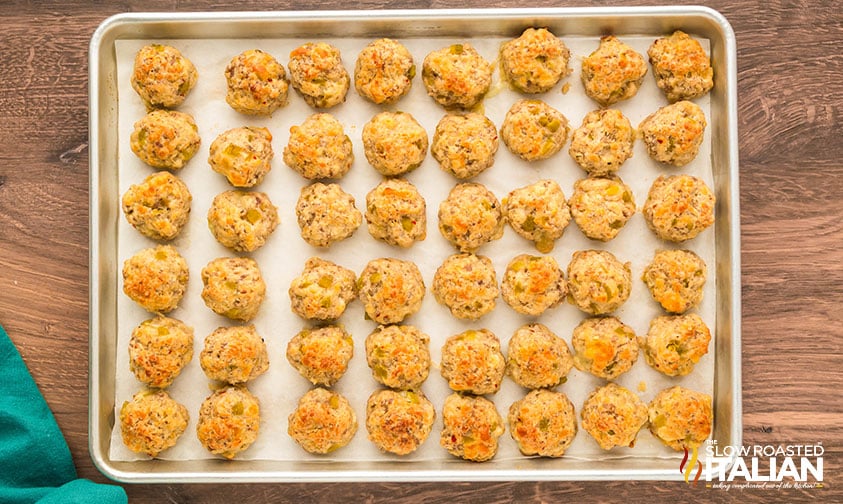 baked sausage poppers on a parchment lined baking sheet
