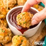 closeup of dipping sausage poppers in sauce