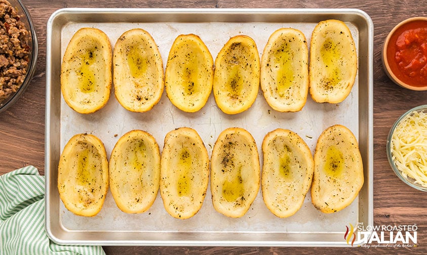scooped out potato skins on a baking sheet