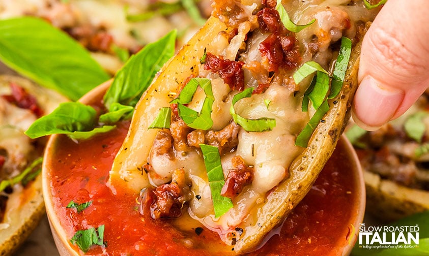 closeup of italian potato skins dipped in marinara