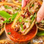 closeup of italian potato skins dipped in marinara