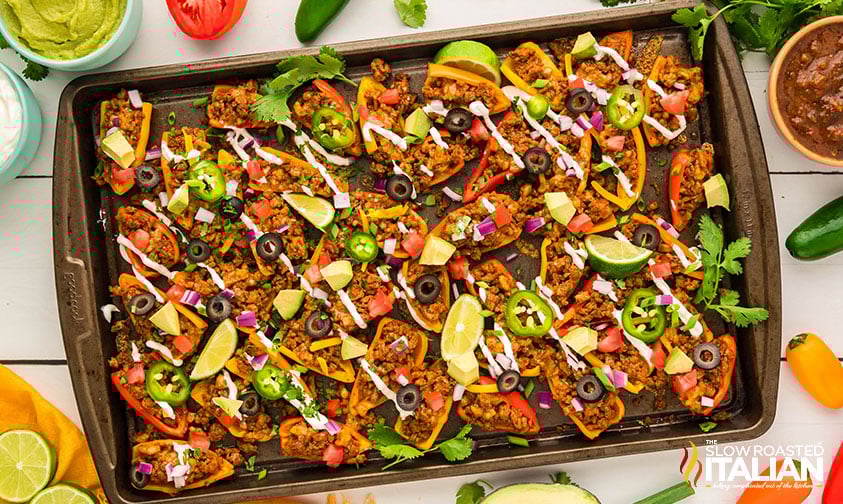 bell pepper nachos with toppings on a sheet pan