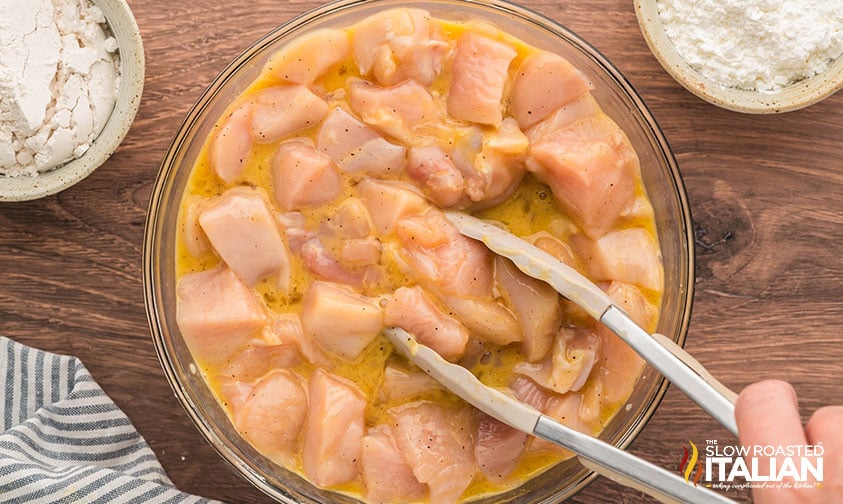 coating pieces of chicken in batter for simple orange chicken recipe