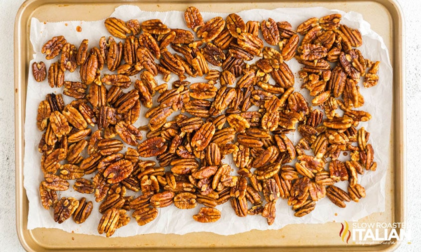 spiced pecans spread on a baking sheet