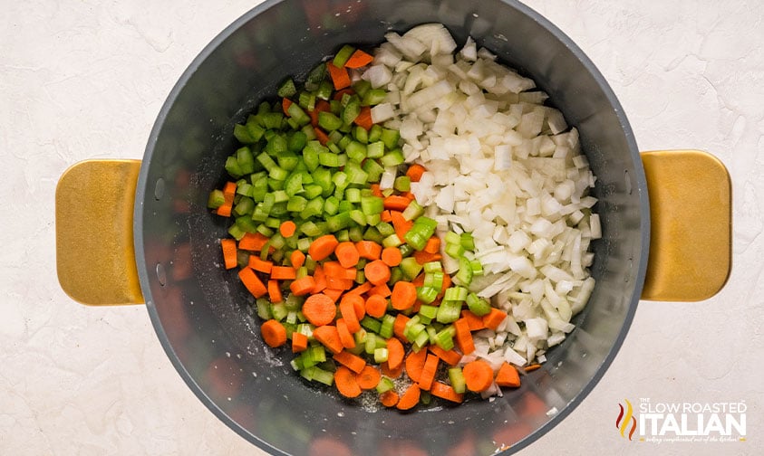 sautéing diced carrots, onions, and celery in a large pot