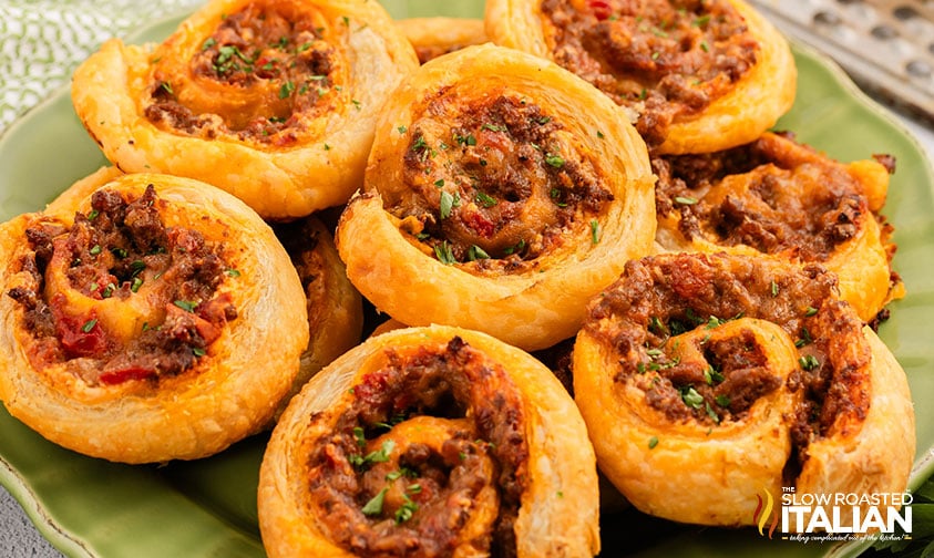 stacked taco pinwheels on a green serving platter