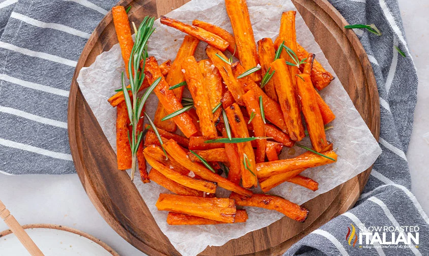 honey glazed air fryer carrots on parchment square on round cutting board