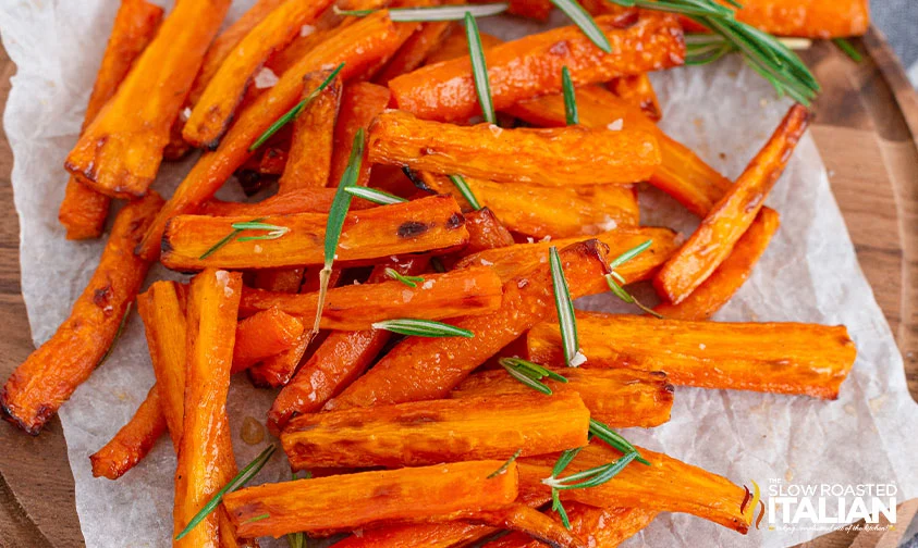 closeup: air fried honey rosemary carrots piled on parchment
