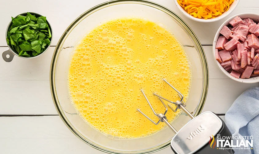 bowls of eggs mixed with an electric mixer