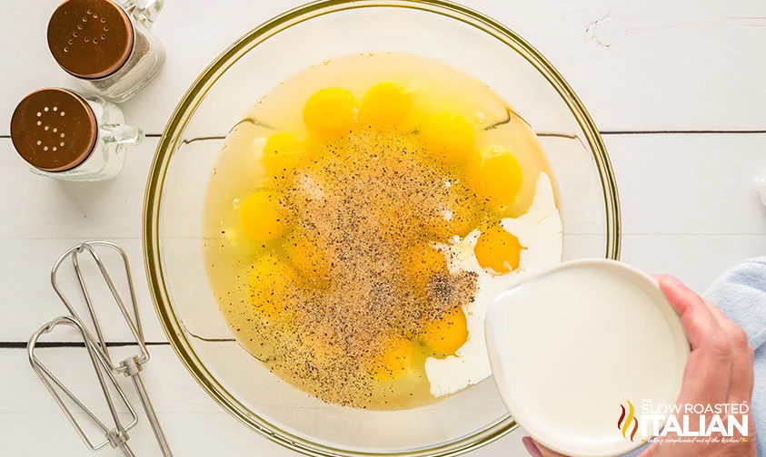 pouring half and half into bowl of seasoned eggs